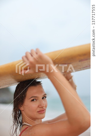Casual Coastal Vacation Moment Capturing Woman With Surfboard Under Warm Sunlight Near Sea 137717555