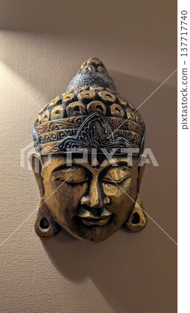 Elegant antique brass Buddha mask with detailed craftsmanship display Elegant antique brass Buddha mask with detailed craftsmanship display 137717740