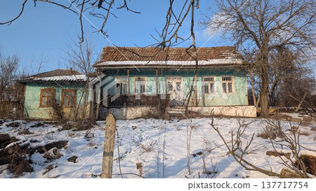 Desolate rural ruin. Weathered rustic farmstead lost to time and nature 137717754