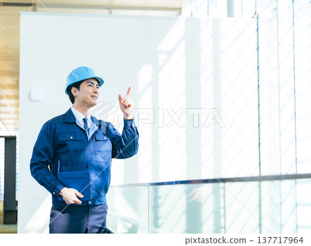 A male worker inspecting a building using a tablet PC A male worker inspecting a building using a tablet PC 137717964