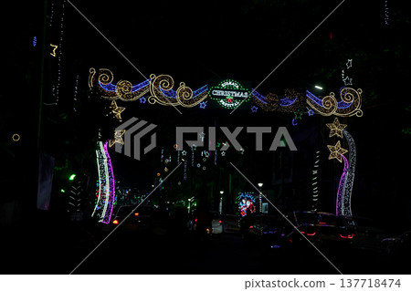 Glow of Festive Christmas Light Arch Over Dark City Street in Kolkata at Night Glow of Festive Christmas Light Arch Over Dark City Street in Kolkata at Night 137718474