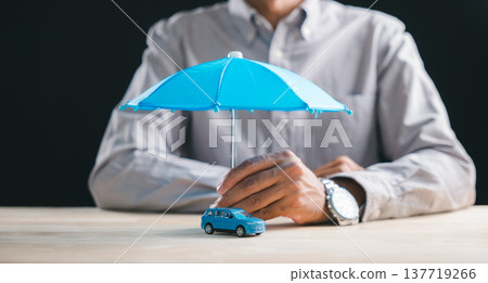 Person secures car insurance plan with umbrella coverage for auto vehicle, representing financial protection against accident damage, driver safety, and policy benefits for future travel claims 137719266