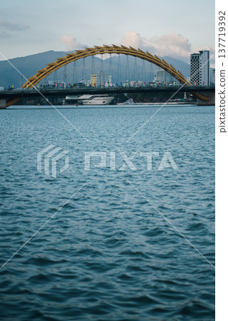 Dragon Bridge crossing Han River in Danang at sunset, iconic Vietnam city landmark, Famous Dragon Bridge cityscape in Da Nang during twilight Dragon Bridge crossing Han River in Danang at sunset, iconic Vietnam city landmark, Famous Dragon Bridge cityscape in Da Nang during twilight 137719392