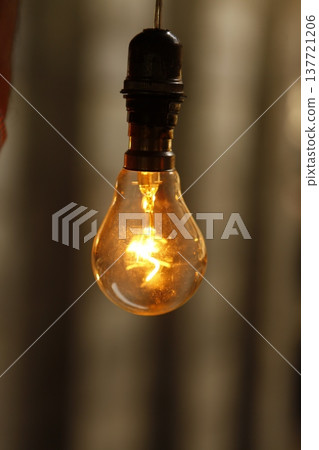 Old model Glow bulb hanging in the dark at night 137721206