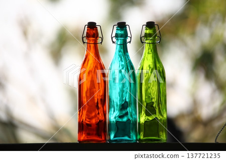 Empty Color Glass Bottle on the table 137721235