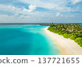 Radiant aerial view of Maldives tropical beach landscape with turquoise water, luxury resort villas, white sand, serene lagoon, idyllic travel destination, panoramic scenic tropical paradise 137721655
