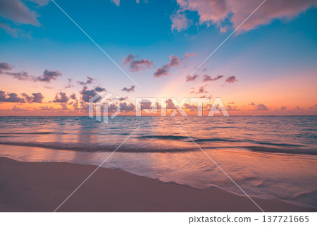 Radiant sunset over tropical beach with calm ocean and peaceful waves, immersive colorful sky and clouds, serene summer nature landscape, idyllic vacation mood Radiant sunset over tropical beach with calm ocean and peaceful waves, immersive colorful sky and clouds, serene summer nature landscape, idyllic vacation mood 137721665