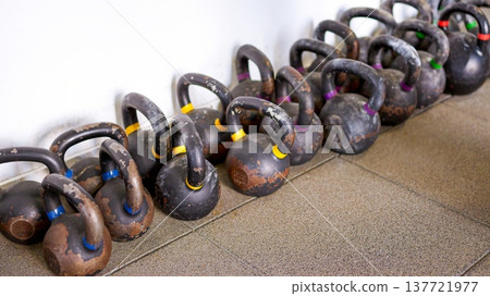 Row of heavy kettlebells for intense training 137721977