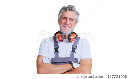 Smiling senior construction worker with safety ear muffs 137721998