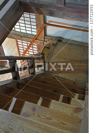 A steep wooden staircase inside the keep of Uwajima Castle, one of the 12 remaining original castle keeps, exuding a sense of history. 137722055
