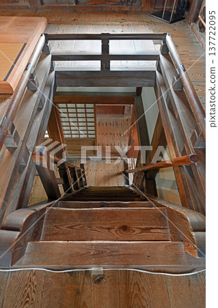 A steep wooden staircase inside the keep of Uwajima Castle, one of the 12 remaining original castle keeps, exuding a sense of history. 137722095
