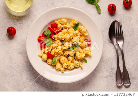 pasta in a plate with tomato sauce. 137722467