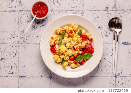 pasta in a plate with tomato sauce. pasta in a plate with tomato sauce. 137722469