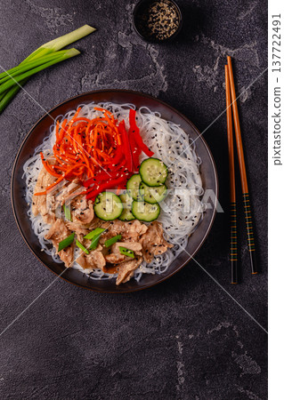 Bowl of rice noodles with vegan soy meat and vegetables. 137722491