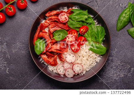 Bowl with vegan fried soy meat and vegetables served with boiled rice. 137722496