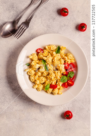 pasta in a plate with tomato sauce. 137722505