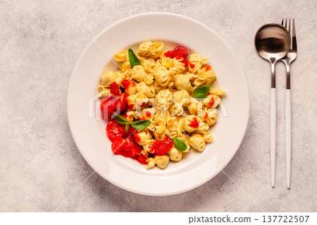 pasta in a plate with tomato sauce. pasta in a plate with tomato sauce. 137722507