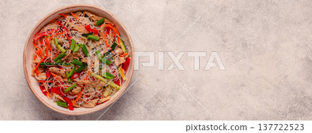 Bowl of rice noodles with vegan soy meat and vegetables. 137722523