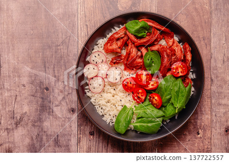 Bowl with vegan fried soy meat and vegetables served with boiled rice. Bowl with vegan fried soy meat and vegetables served with boiled rice. 137722557