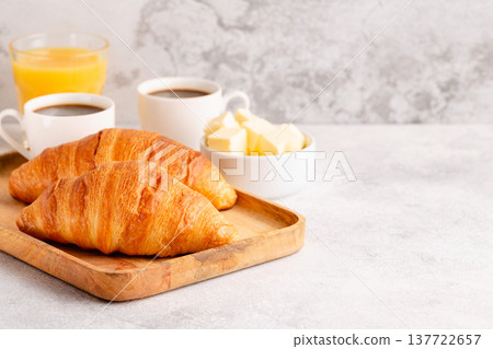 Hot coffee, croissants on a light background, selective focus. Hot coffee, croissants on a light background, selective focus. 137722657