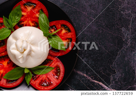 Caprese salad with tomatoes, burrata cheese and basil. Caprese salad with tomatoes, burrata cheese and basil. 137722659