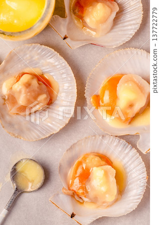 Raw scallops with melted butter Raw scallops with melted butter 137722779