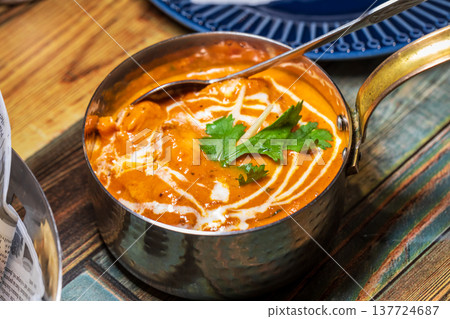 Various rich Indian curries served in traditional copper pots Various rich Indian curries served in traditional copper pots 137724687