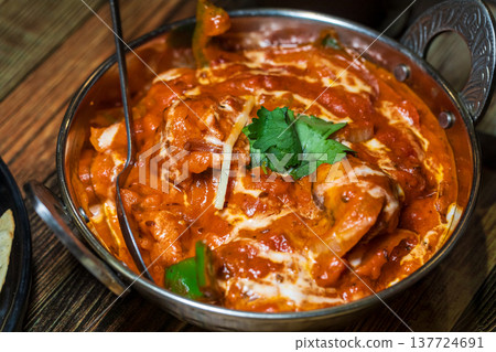 Various rich Indian curries served in traditional copper pots Various rich Indian curries served in traditional copper pots 137724691