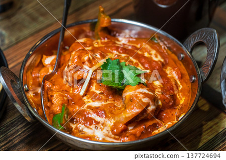 Various rich Indian curries served in traditional copper pots 137724694