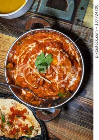 Various rich Indian curries served in traditional copper pots Various rich Indian curries served in traditional copper pots 137724700