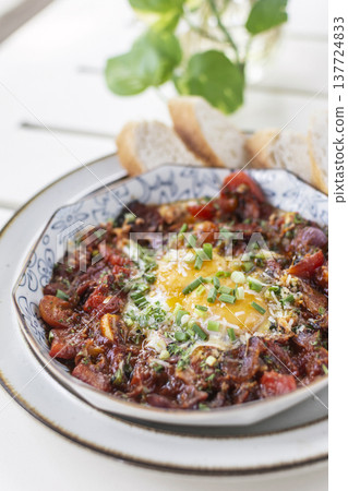 Shakshuka brunch dish on white table at outdoors restaurant in israel Shakshuka brunch dish on white table at outdoors restaurant in israel 137724833
