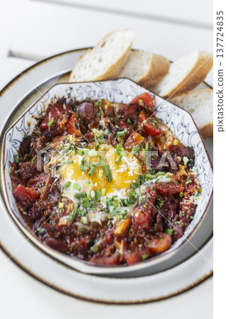 Shakshuka brunch dish on white table at outdoors restaurant in israel 137724835