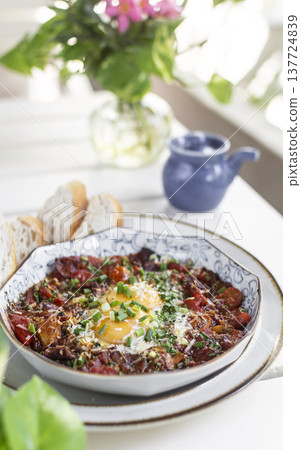Shakshuka brunch dish on white table at outdoors restaurant in israel Shakshuka brunch dish on white table at outdoors restaurant in israel 137724839