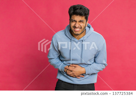 Indian man feeling sudden strong abdominal stomach ache, gastritis problem, diarrhea, poisoning 137725384