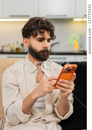 Indian man freelance worker using smartphone for online client chat remote job typing message text Indian man freelance worker using smartphone for online client chat remote job typing message text 137725431