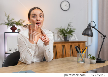 Young businesswoman records voice message states argument and listens to reply on smartphone speaker Young businesswoman records voice message states argument and listens to reply on smartphone speaker 137725442