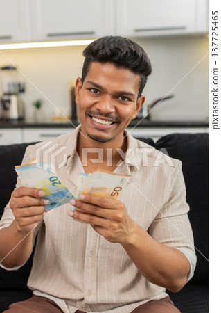 Indian man counts euro cash happy makes money gesture plans dream purchase savings bonus invest plan Indian man counts euro cash happy makes money gesture plans dream purchase savings bonus invest plan 137725465