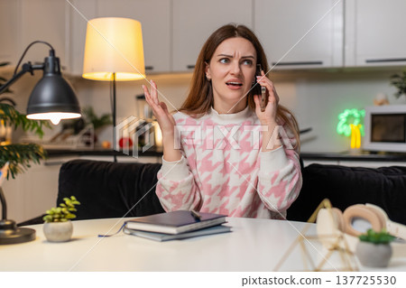 Adult woman shouts on smartphone at night rejects offer angry frown strong emotion stress upset mood Adult woman shouts on smartphone at night rejects offer angry frown strong emotion stress upset mood 137725530