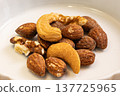 Nuts served on a white plate 137725965