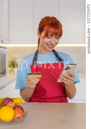 Young woman at bar checks grocery order on smartphone confirms payment with bank card approval done 137725975