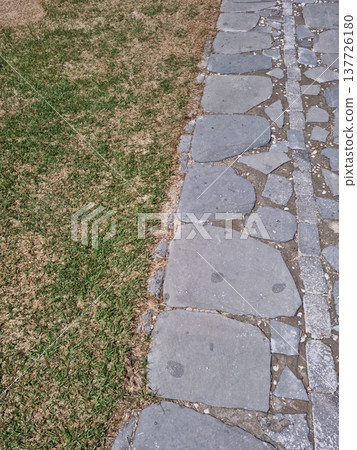 Close-up of the stone floor and grass. 137726180