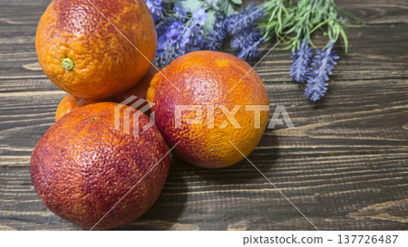 Fresh citrus fruits: red oranges and tangerines on a wooden table Healthy eating Fresh citrus fruits: red oranges and tangerines on a wooden table Healthy eating 137726487