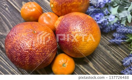 Fresh citrus fruits: red oranges and tangerines on a wooden table Healthy eating Fresh citrus fruits: red oranges and tangerines on a wooden table Healthy eating 137726488