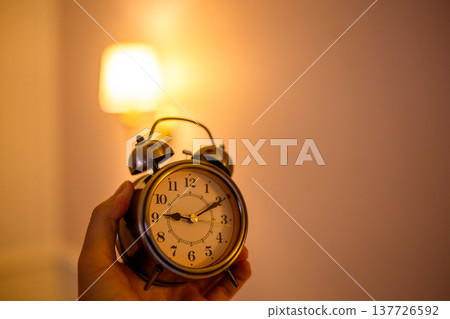 A retro handheld alarm clock 137726592