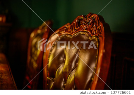 The back of a heavy, leather-upholstered chair The back of a heavy, leather-upholstered chair 137726601