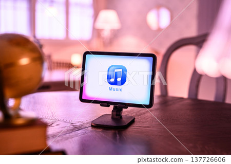 A music tablet illuminated by purple light 137726606