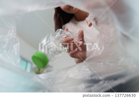 Sustainability. Woman recycling plastic bottle for eco-friendly living. Sustainability. Woman recycling plastic bottle for eco-friendly living. 137726630