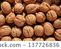 Domestic walnuts in their shells 137726836