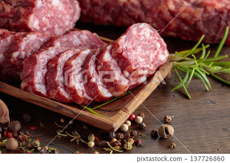 Sliced smoked sausage with herbs and spices. 137726860