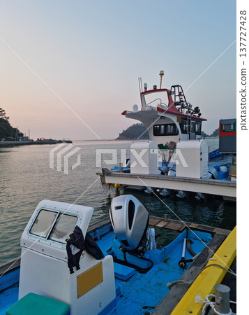 It is a seascape with a fishing boat. 137727428